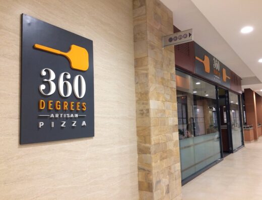 An image showing a signage of 360 Degrees Pizza Restaurant