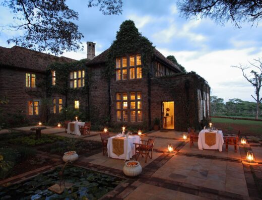 Giraffe Manor showing an outside set up with light ambiance in the building