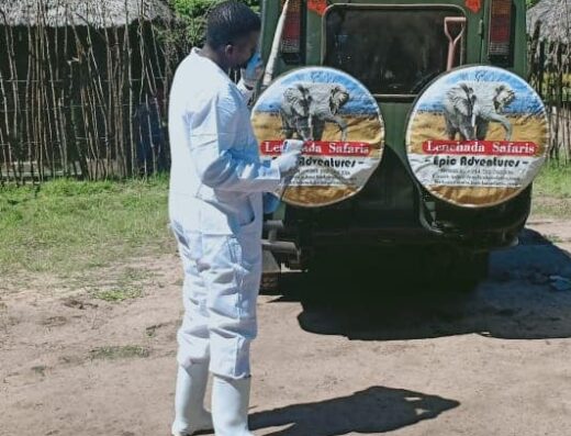 Lenchada Safaris showing a guide pointing at the tourists vehicle